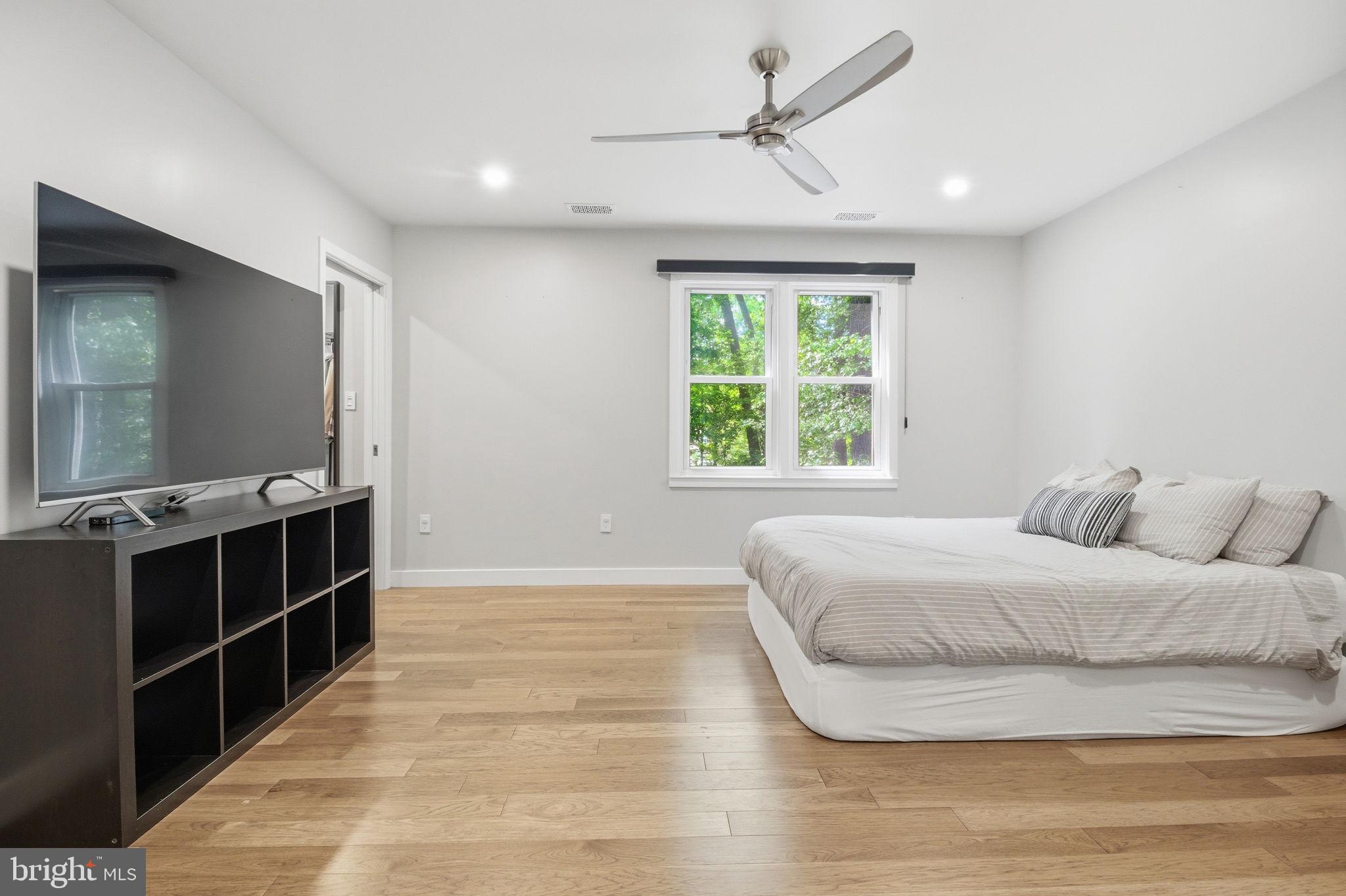 407 Autumn Olive Way Sterling, VA 20164 - Photo 21 of 47 a bedroom with a large bed and a chandelier