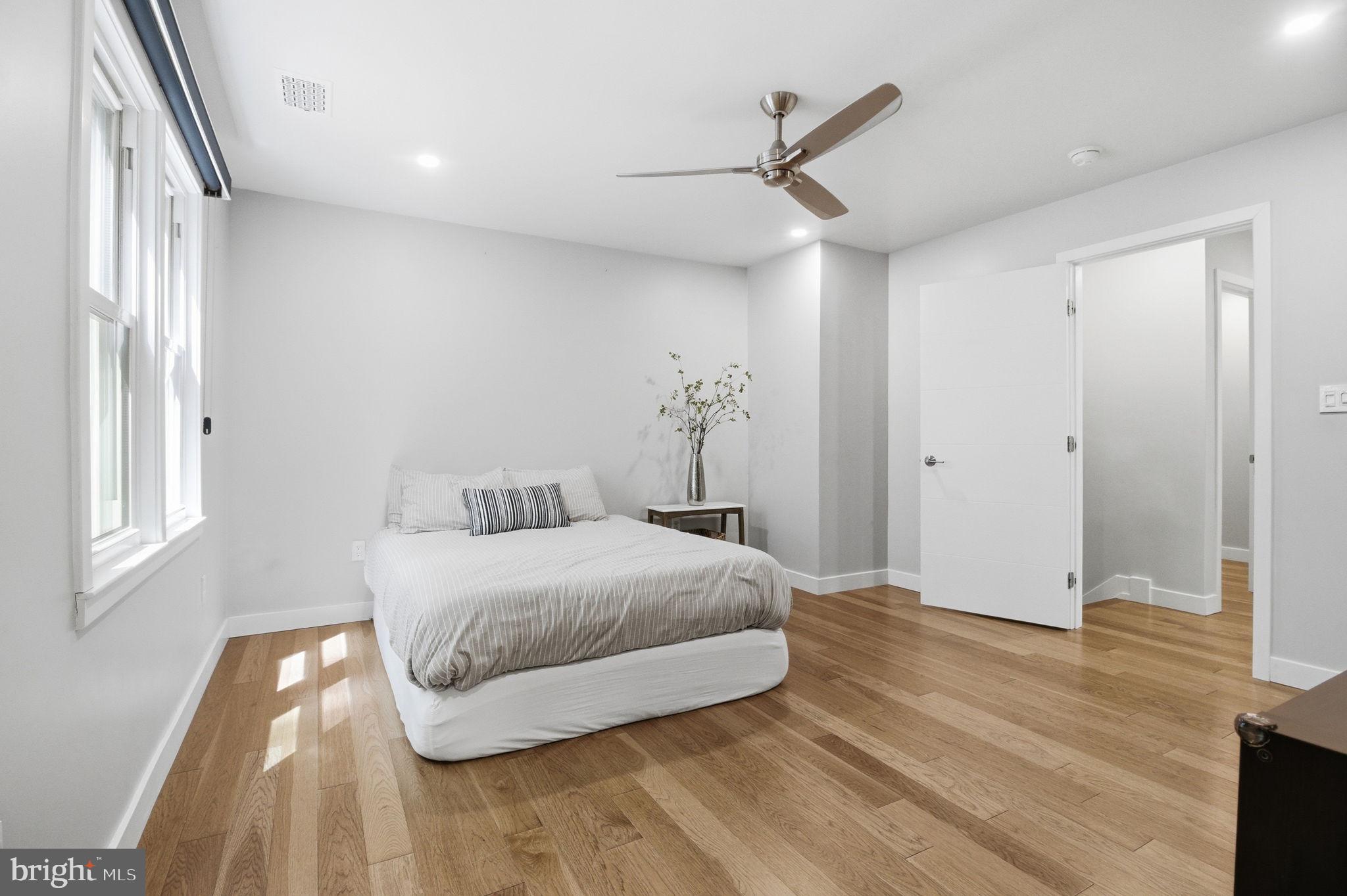 407 Autumn Olive Way Sterling, VA 20164 - Photo 22 of 47 a bedroom with a bed and wooden floor