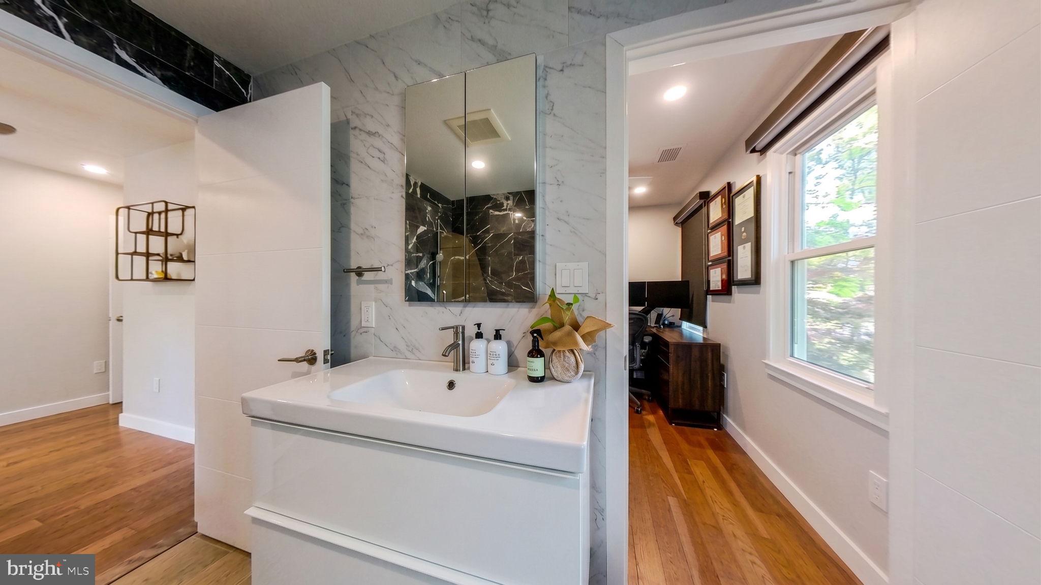 407 Autumn Olive Way Sterling, VA 20164 - Photo 29 of 47 a en suite bathroom with a sink a mirror and a shower