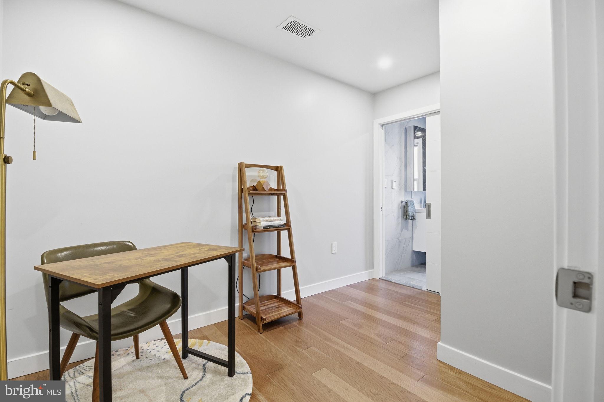 407 Autumn Olive Way Sterling, VA 20164 - Photo 32 of 47 a view of a hallway with wooden floor and a bathroom