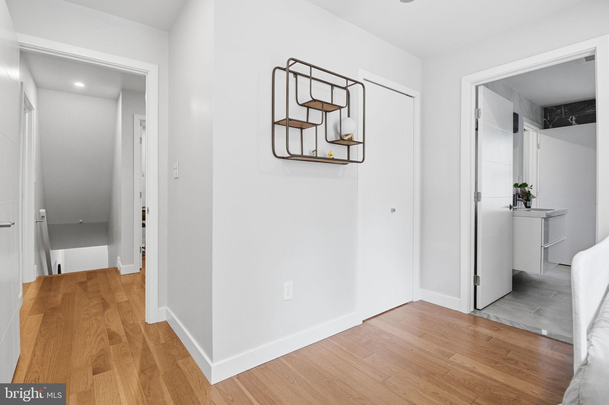 407 Autumn Olive Way Sterling, VA 20164 - Photo 35 of 47 a view of a hallway with wooden floor and a bathroom