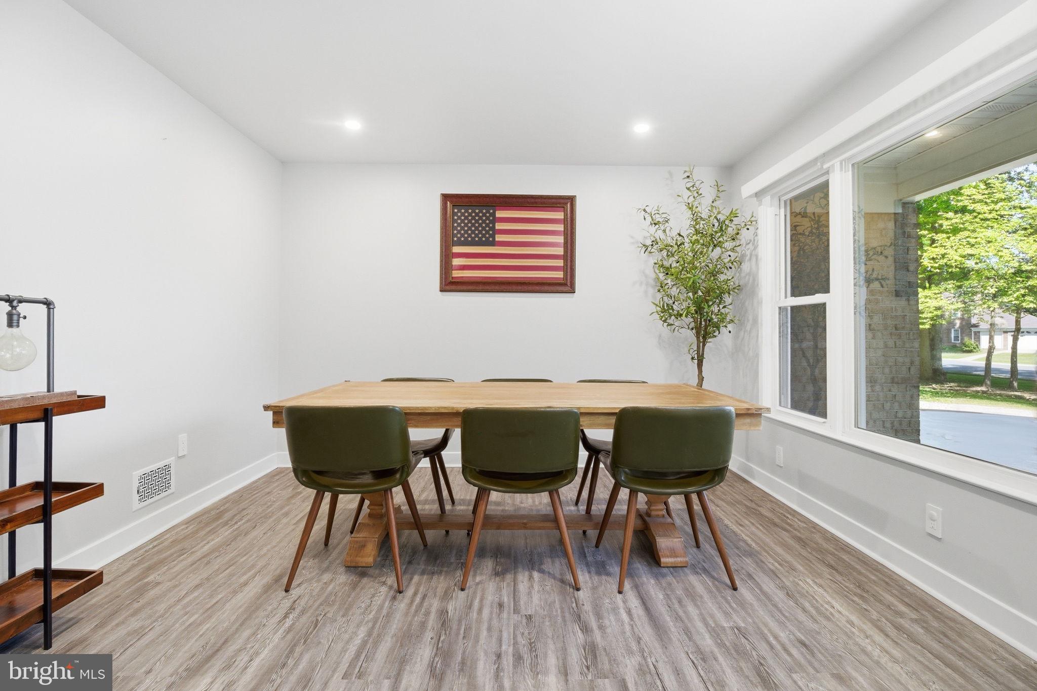 407 Autumn Olive Way Sterling, VA 20164 - Photo 6 of 47 a view of a dining room with furniture and wooden floor