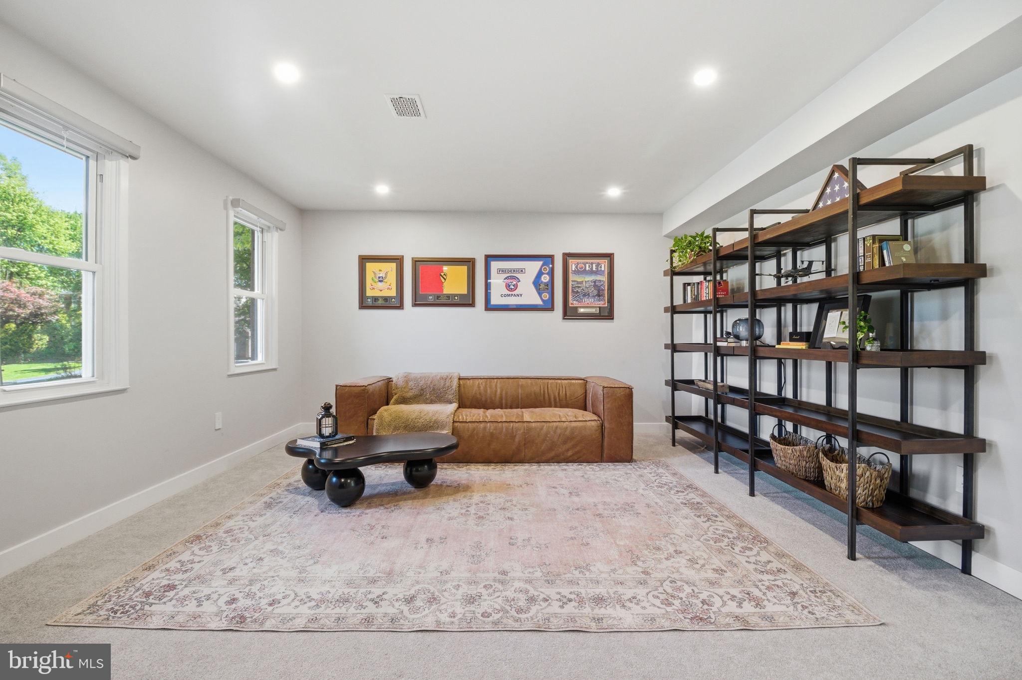 407 Autumn Olive Way Sterling, VA 20164 - Photo 8 of 47 a living room with furniture and a book shelf