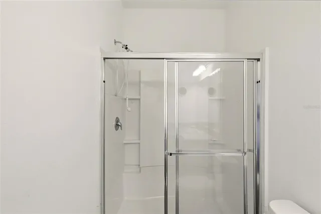 a bathroom with a glass shower door