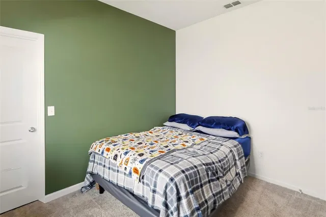 a bedroom with a bed and a cabinets