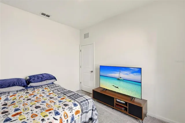 a bedroom with a bed and a dresser