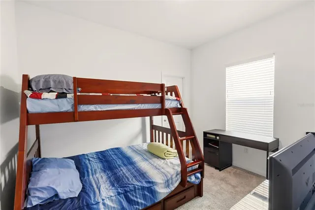 a bedroom with a bed and window