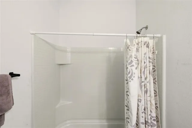 a bathroom with a shower curtain and a shower curtain