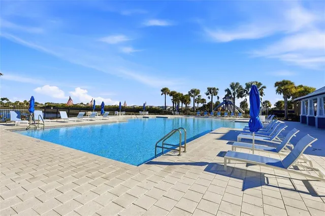 a view of swimming pool with outdoor seating and a city view