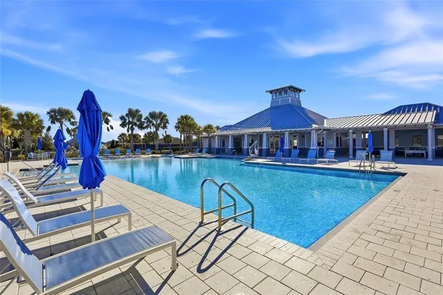 a view of a house with swimming pool and sitting area