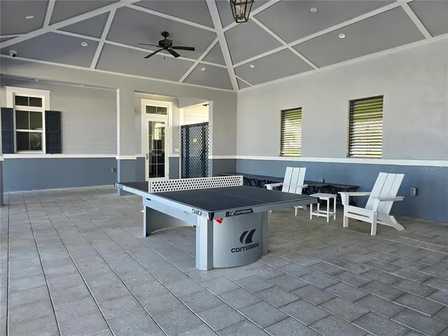 a view of a patio with table and chairs