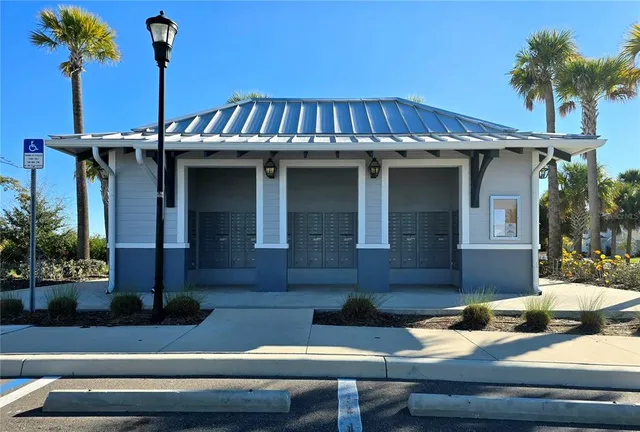 a view of a house with pool and chairs