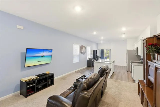 a living room with furniture flat screen tv and a couch