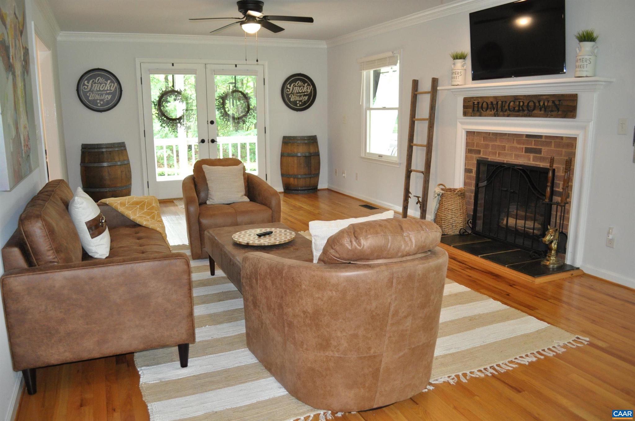 3257 Martin Kings Road Charlottesville, VA 22902 - Photo 7 of 49 a living room with furniture a fireplace and a flat screen tv
