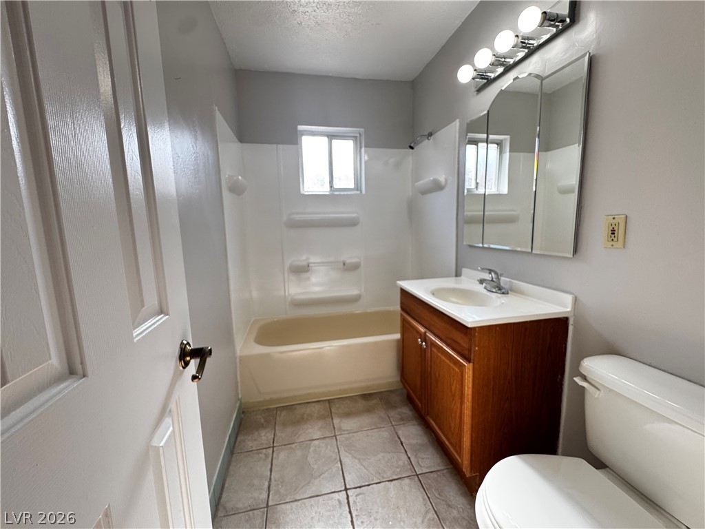 350 East Desert Inn Road, Unit C103 Las Vegas, NV 89109 - Photo 8 of 23 Well-maintained bathroom features a full bath with shower, tile flooring, and a window for natural illumination.
