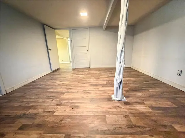 a view of room with wooden floor and closet