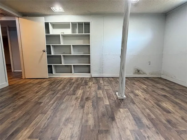 a view of an empty room with wooden door