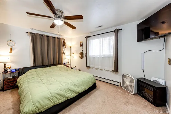 a bed room with a bed and a wooden floor