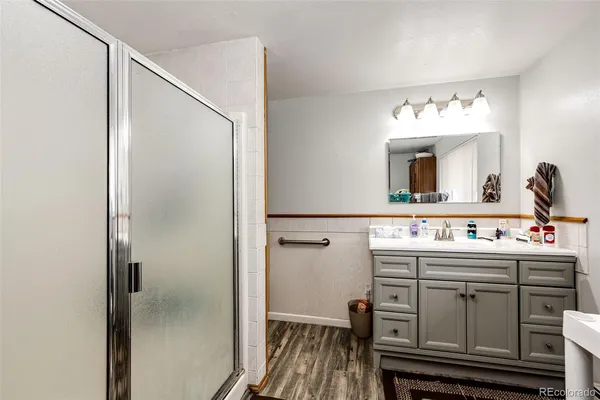 a bathroom with a sink a toilet and shower