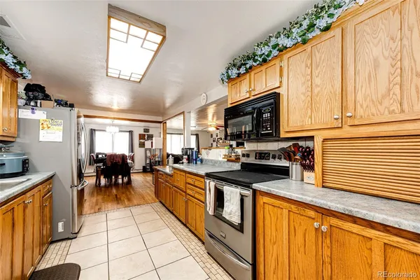 a view of a kitchen with refrigerator and workspace
