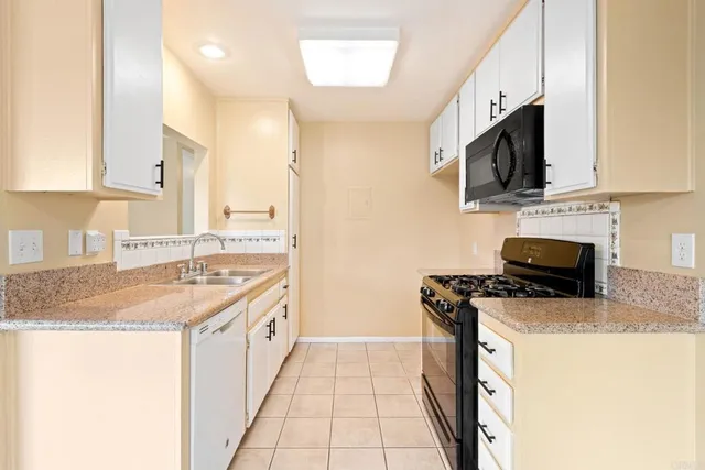 a kitchen with stainless steel appliances granite countertop a sink stove and microwave