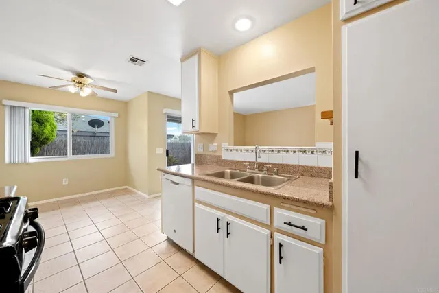 a bathroom with a granite countertop sink mirror and vanity