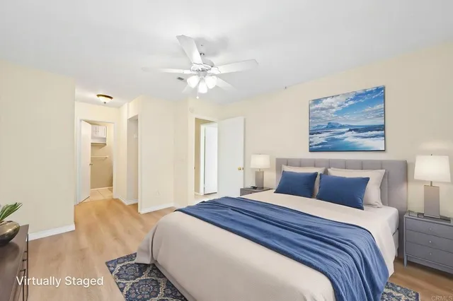 a bedroom with a large bed and a chandelier