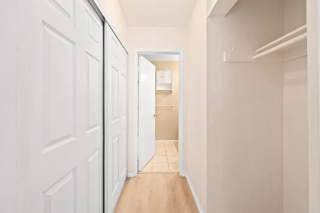 a view of a hallway with wooden floor and entryway