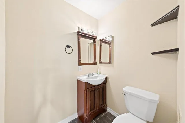 a bathroom with a toilet sink and mirror