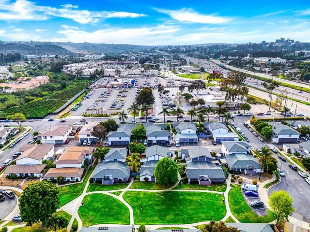 an aerial view of residential houses with outdoor space