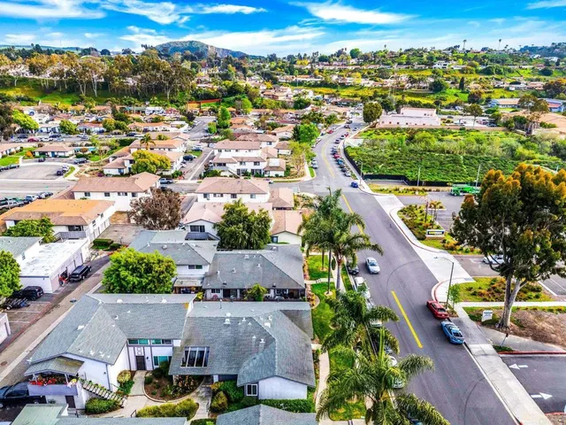 an aerial view of residential houses with outdoor space