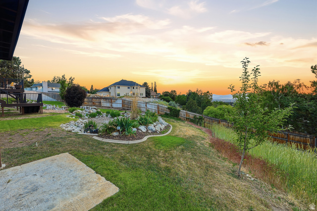 2342 Charros Road Sandy, UT 84092 - Photo 72 of 94 Expansive backyard featuring a multi-level wooden deck, concrete patio, established rock garden, and privacy fencing