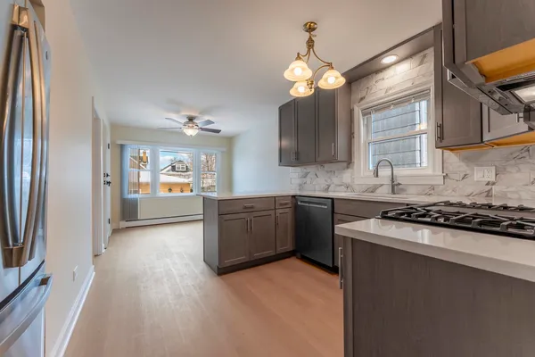 a kitchen with stainless steel appliances granite countertop a sink stove and refrigerator