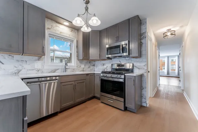 a kitchen with stainless steel appliances granite countertop a stove and a sink