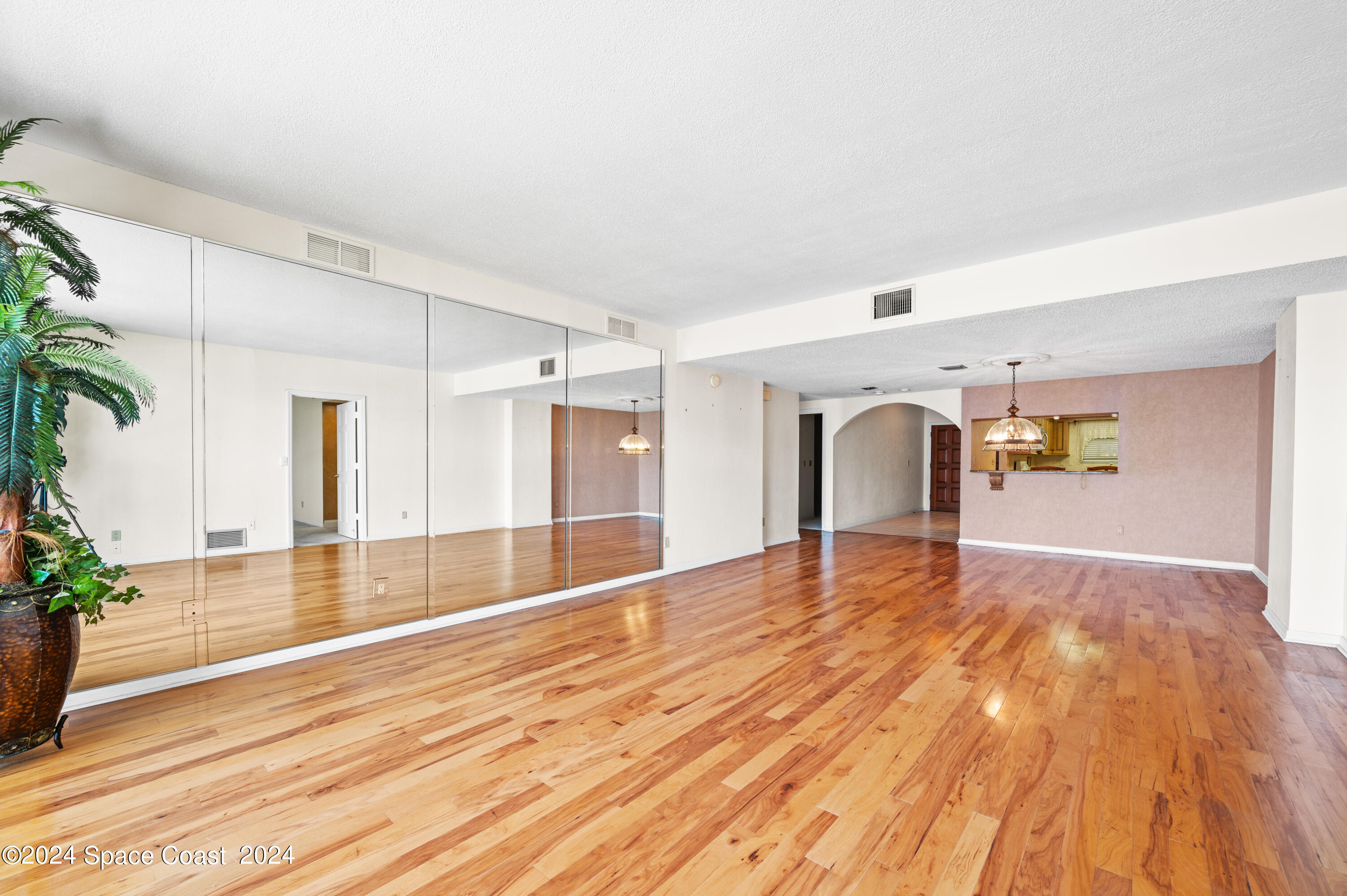 750 North Atlantic Avenue, Unit 608 Cocoa Beach, FL 32931 - Photo 11 of 39 a view of empty room with wooden floor and plants