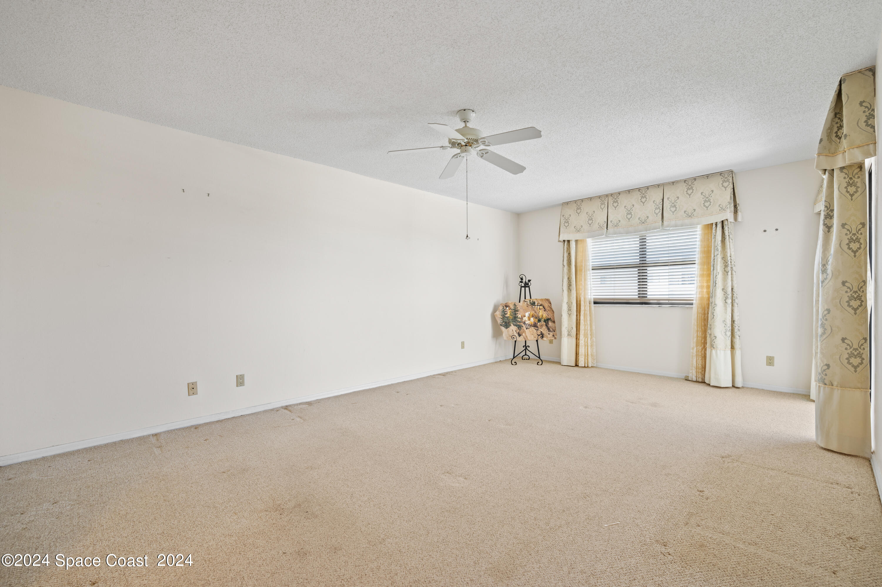 750 North Atlantic Avenue, Unit 608 Cocoa Beach, FL 32931 - Photo 12 of 39 an empty room with windows and closet