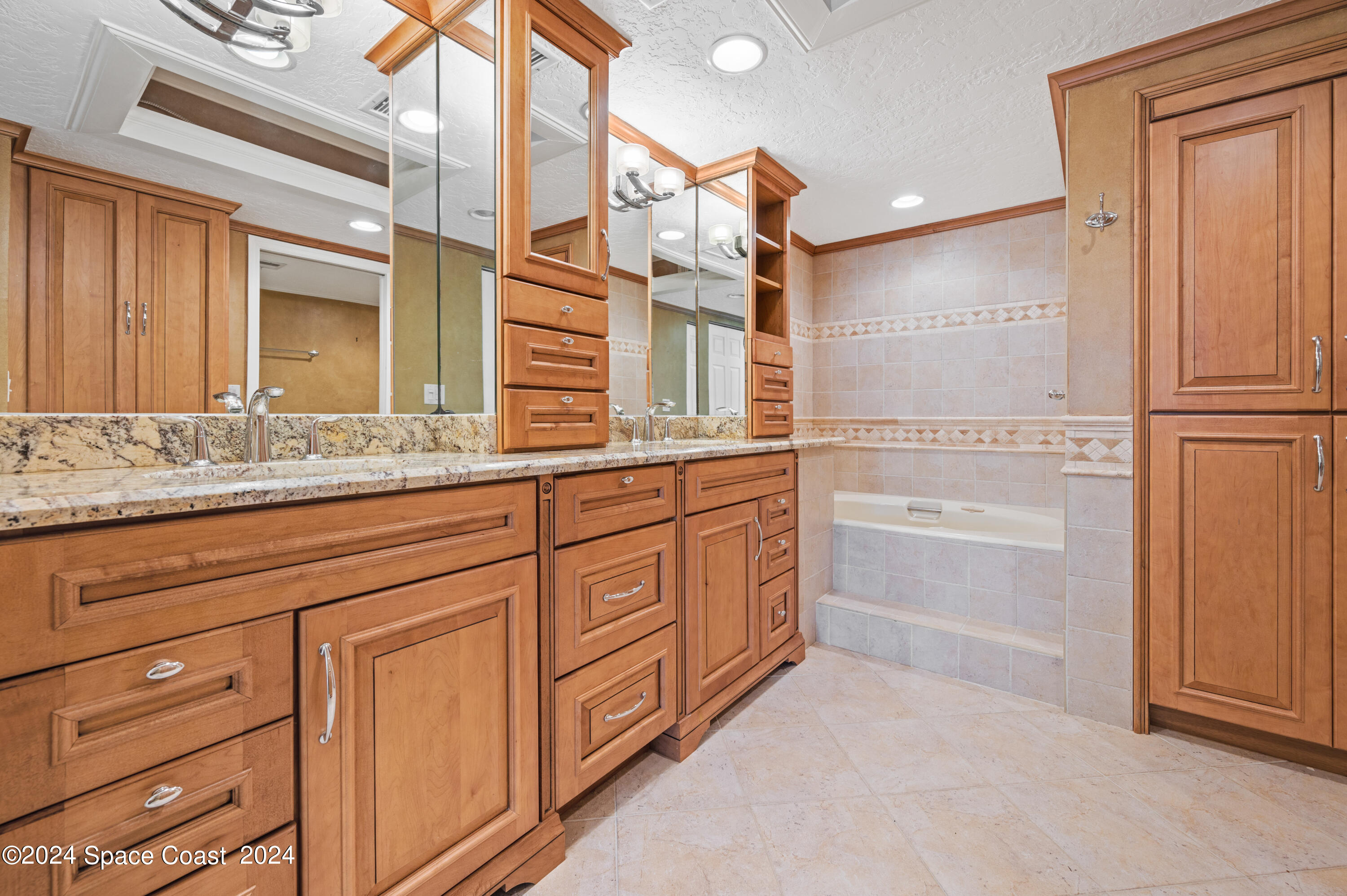 750 North Atlantic Avenue, Unit 608 Cocoa Beach, FL 32931 - Photo 17 of 39 a bathroom with a sink a vanity and a mirror