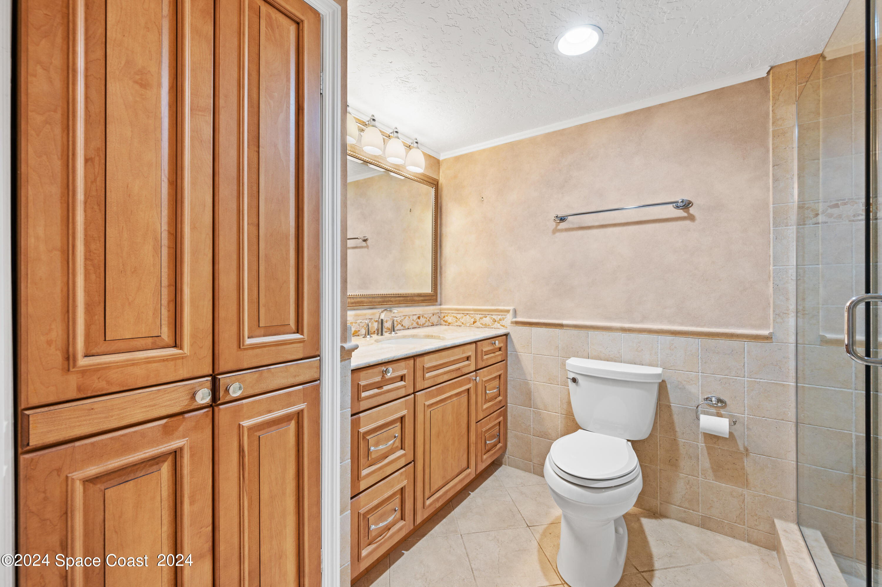 750 North Atlantic Avenue, Unit 608 Cocoa Beach, FL 32931 - Photo 21 of 39 a bathroom with a toilet a sink and shower