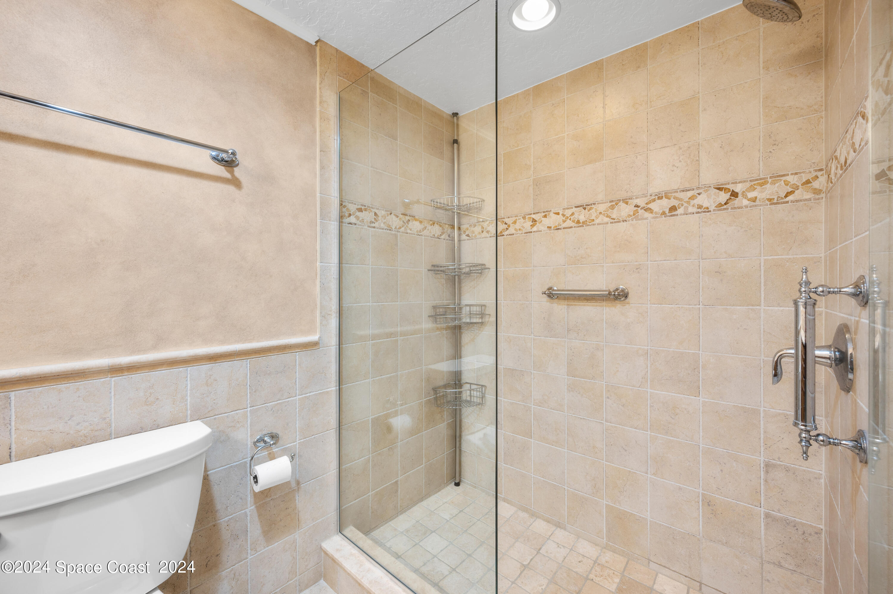 750 North Atlantic Avenue, Unit 608 Cocoa Beach, FL 32931 - Photo 22 of 39 a bathroom with a shower and a toilet
