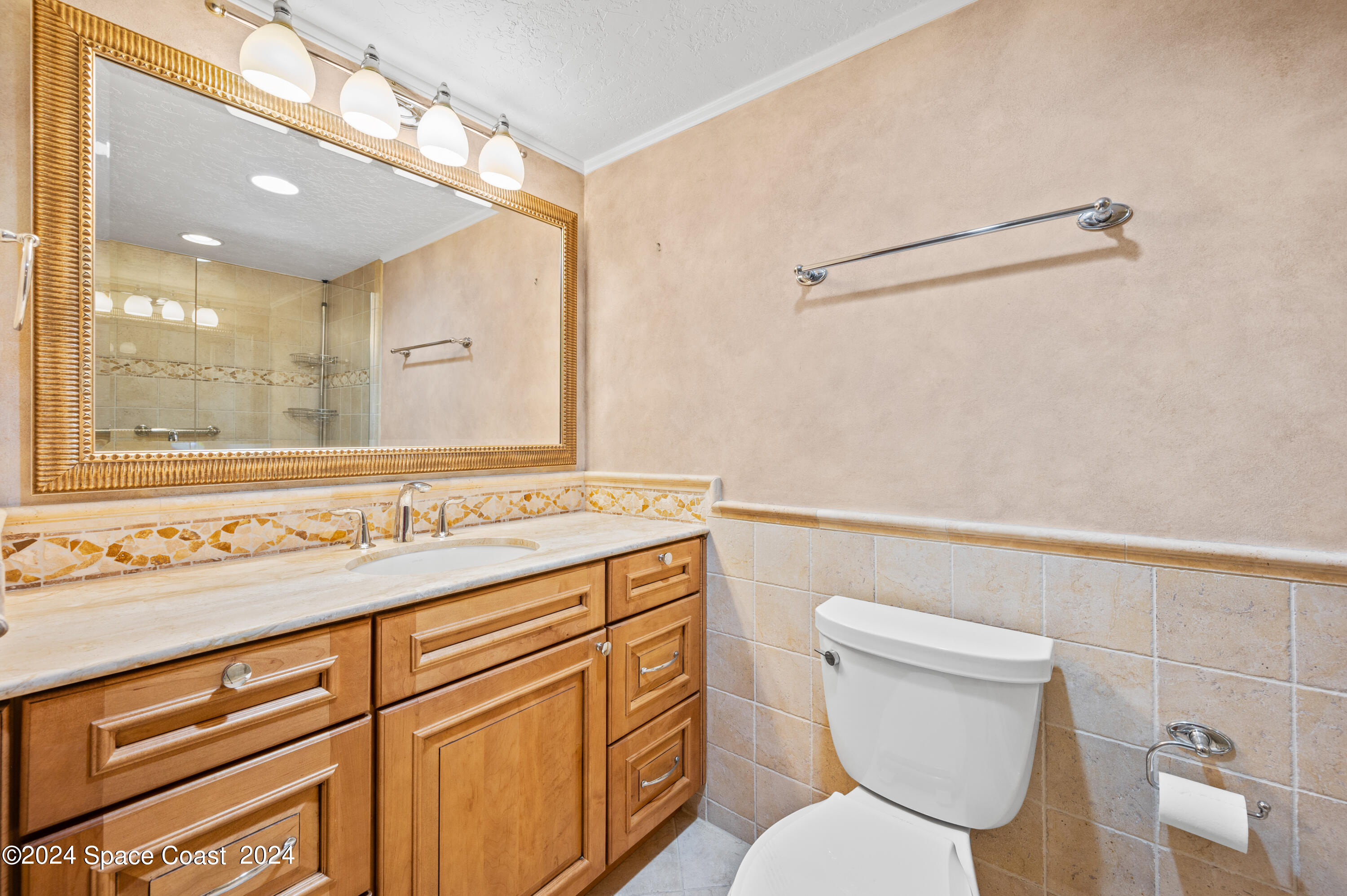 750 North Atlantic Avenue, Unit 608 Cocoa Beach, FL 32931 - Photo 23 of 39 a bathroom with a toilet sink and mirror