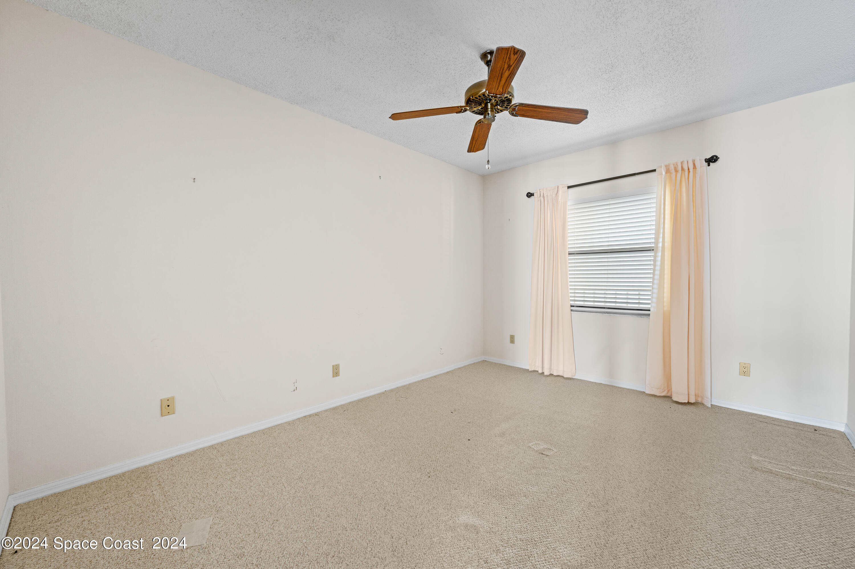 750 North Atlantic Avenue, Unit 608 Cocoa Beach, FL 32931 - Photo 26 of 39 a view of a livingroom and a ceiling fan