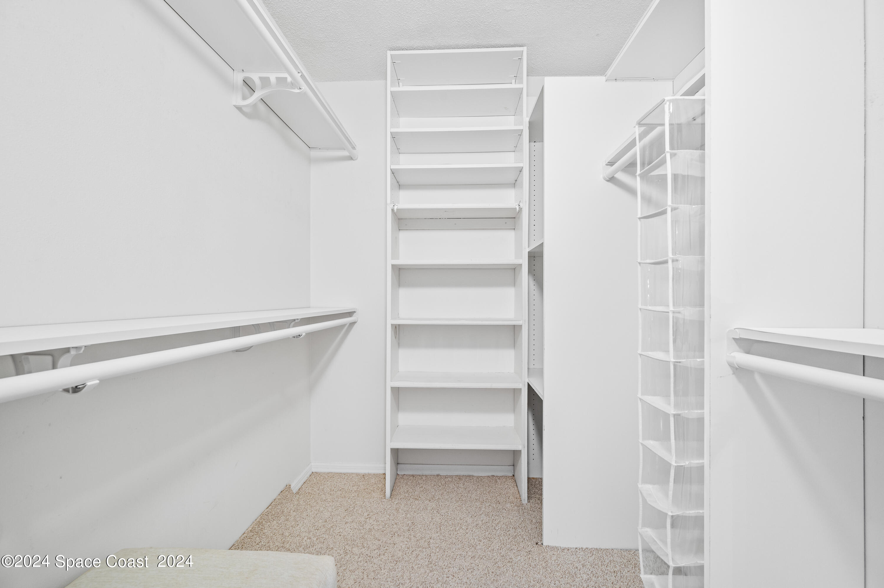 750 North Atlantic Avenue, Unit 608 Cocoa Beach, FL 32931 - Photo 27 of 39 a view of walk in closet with empty racks