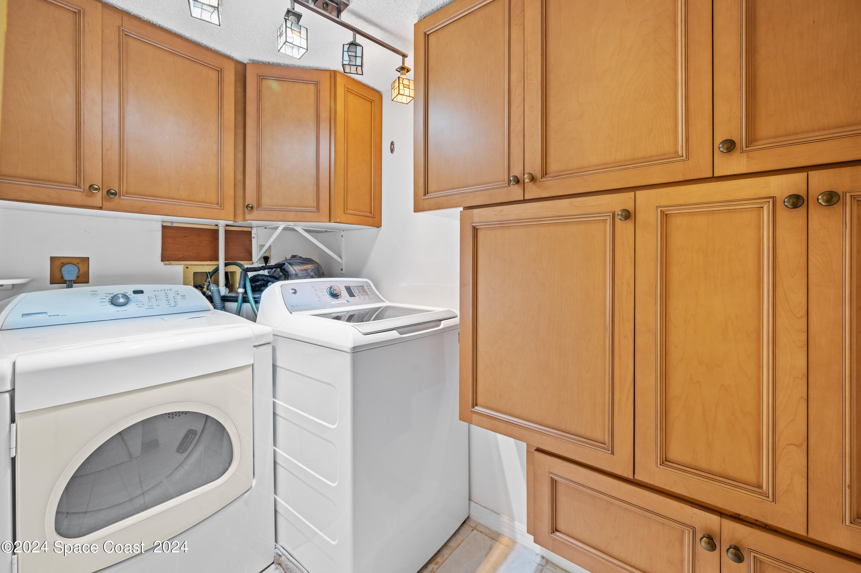 750 North Atlantic Avenue, Unit 608 Cocoa Beach, FL 32931 - Photo 28 of 39 a utility room with dryer and washer