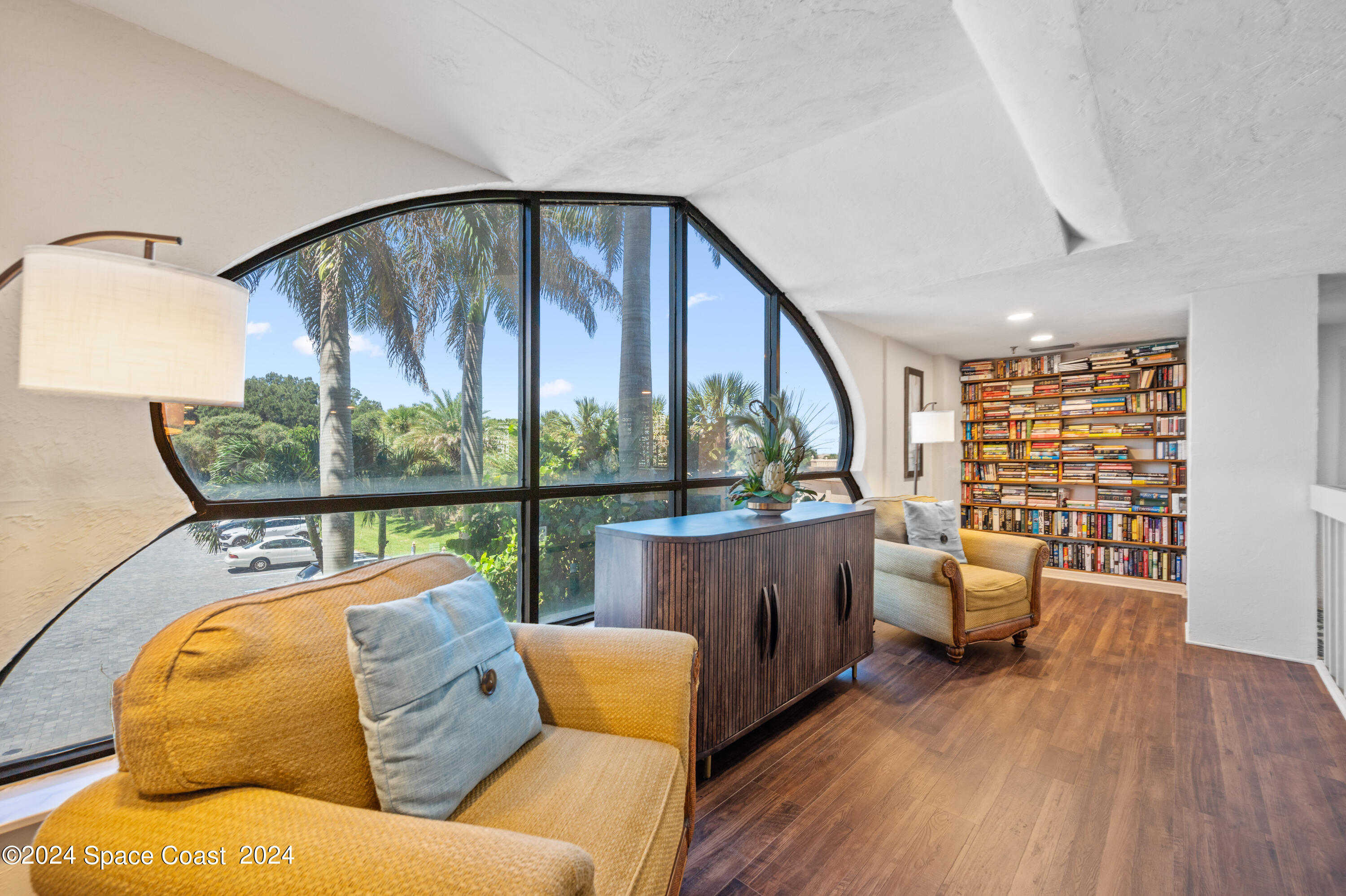 750 North Atlantic Avenue, Unit 608 Cocoa Beach, FL 32931 - Photo 34 of 39 a living room with furniture and a floor to ceiling window
