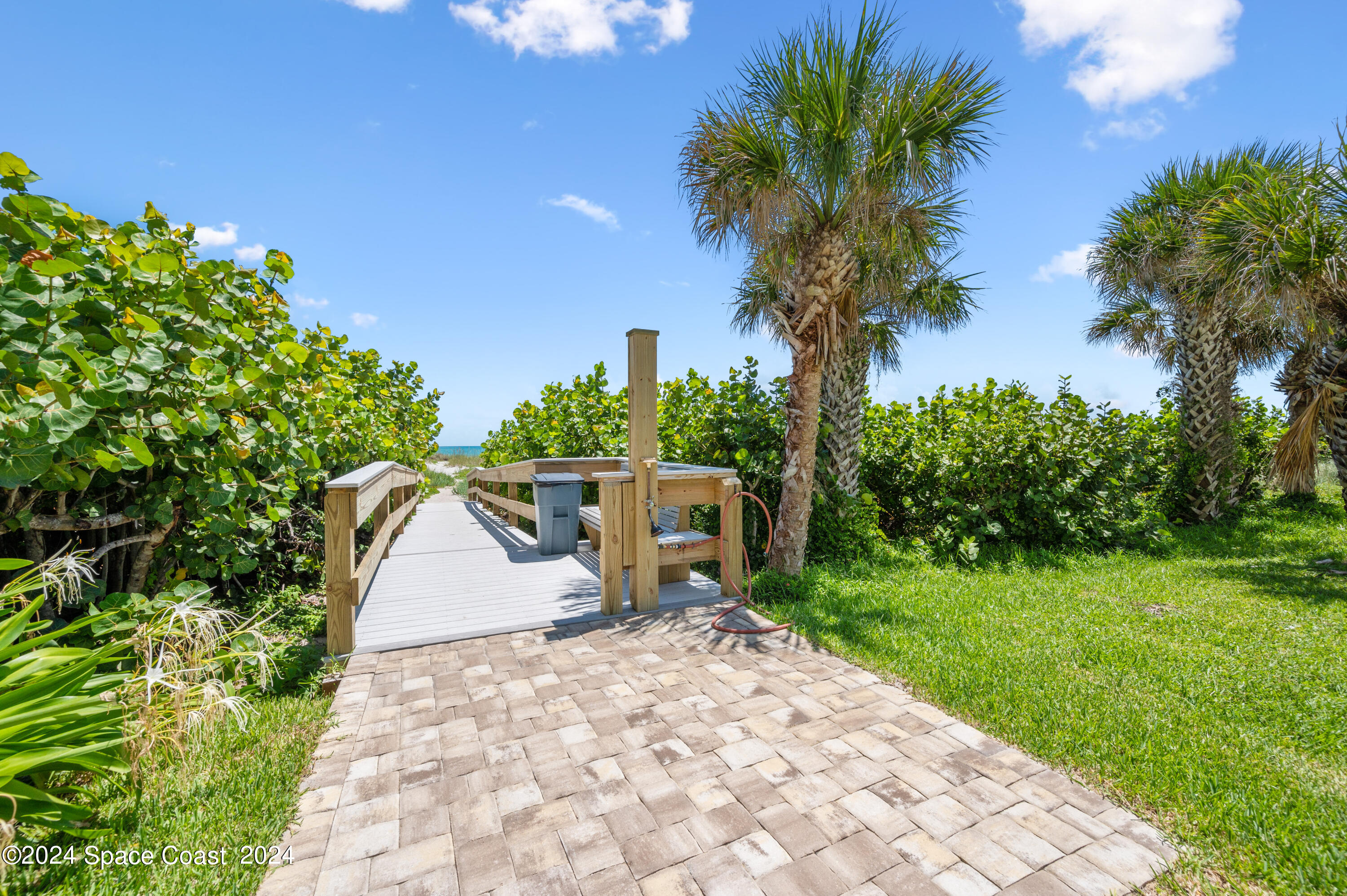 750 North Atlantic Avenue, Unit 608 Cocoa Beach, FL 32931 - Photo 36 of 39 a view of a backyard with a garden