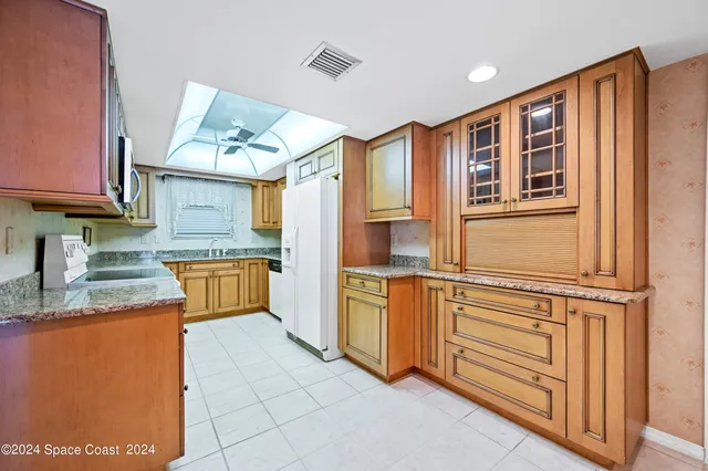 a kitchen with stainless steel appliances granite countertop a sink and cabinets
