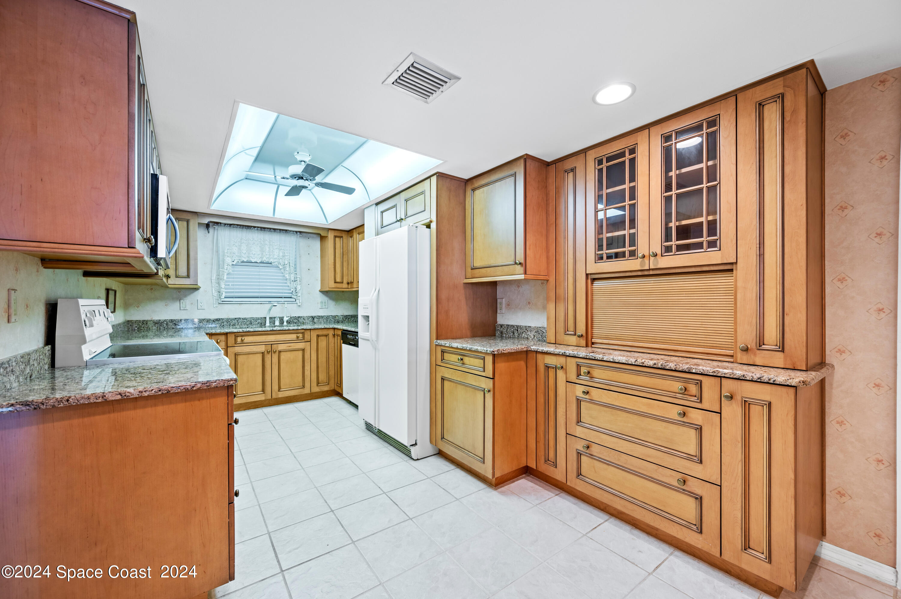 750 North Atlantic Avenue, Unit 608 Cocoa Beach, FL 32931 - Photo 6 of 39 a kitchen with stainless steel appliances granite countertop a sink and cabinets