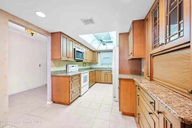 a kitchen with stainless steel appliances granite countertop a sink and cabinets