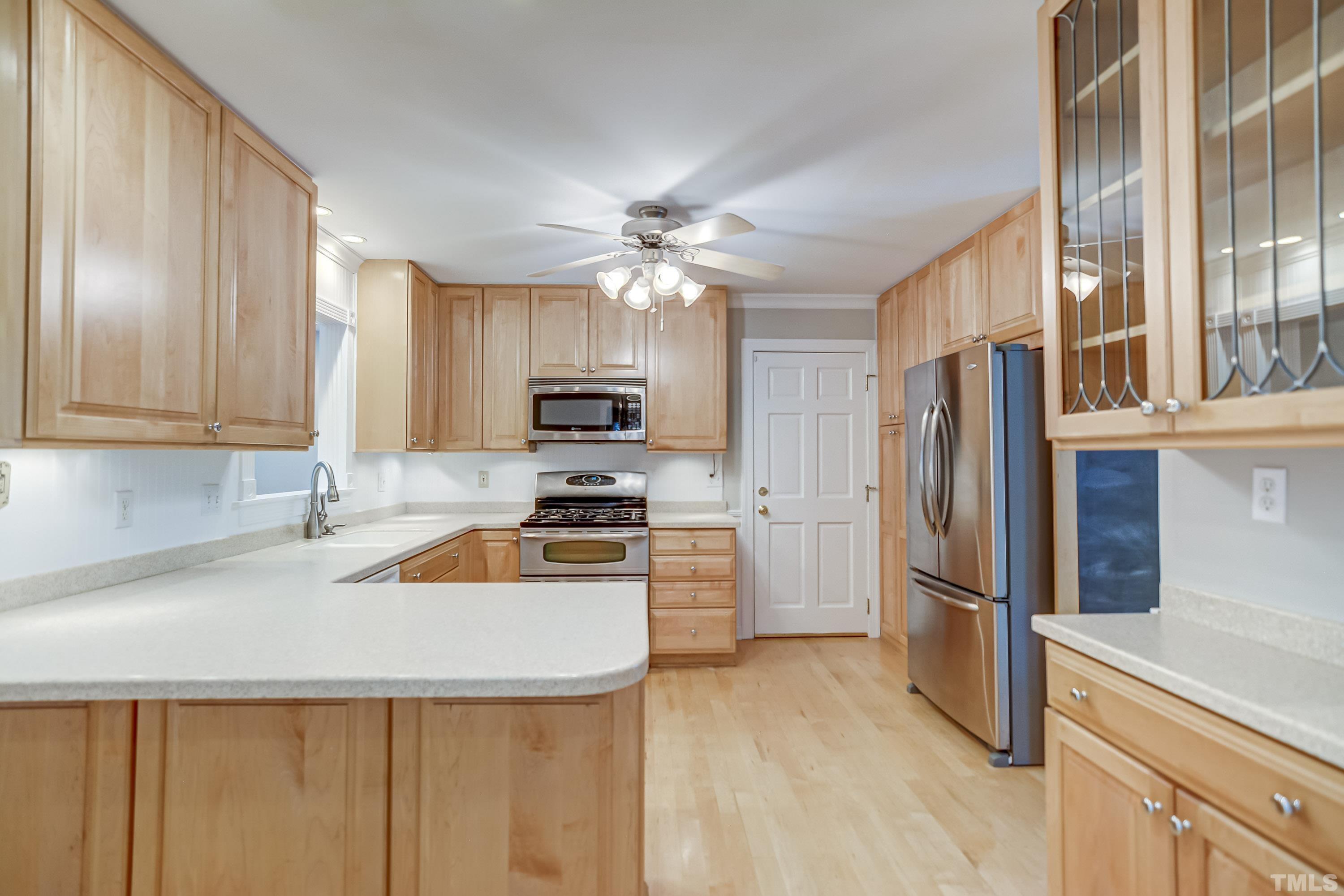 8313 Seagate Drive Raleigh, NC 27615 - Photo 7 of 24 a kitchen with stainless steel appliances a refrigerator sink and microwave