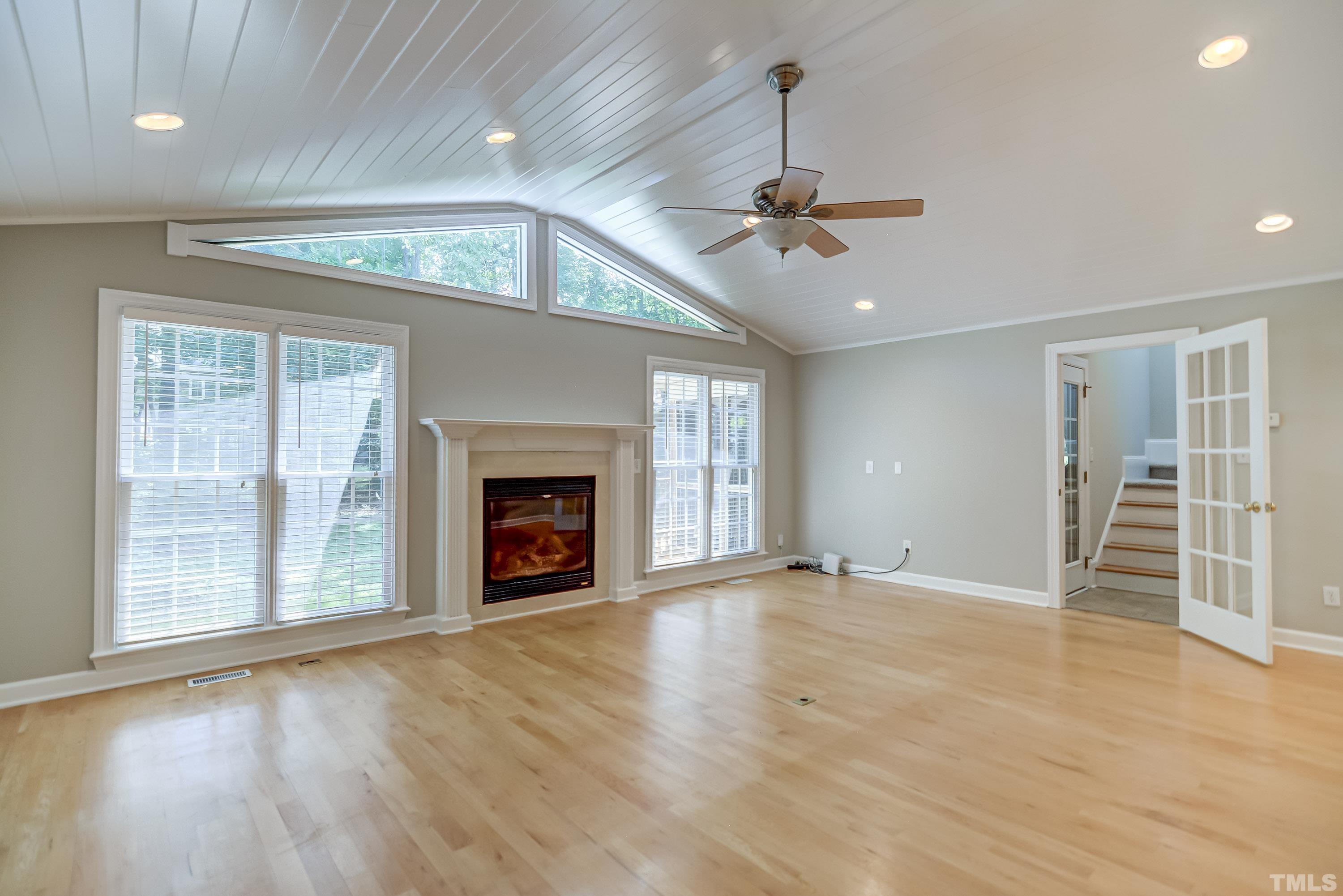 8313 Seagate Drive Raleigh, NC 27615 - Photo 9 of 24 a view of an empty room with a fireplace and a window